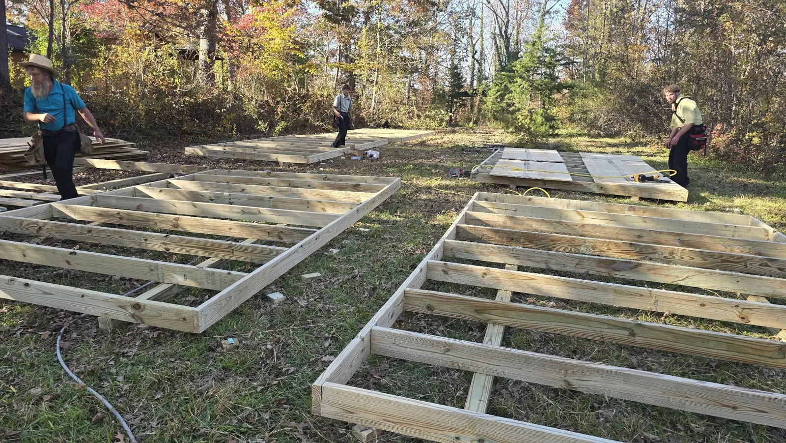 Volunteers building cabin floor frames