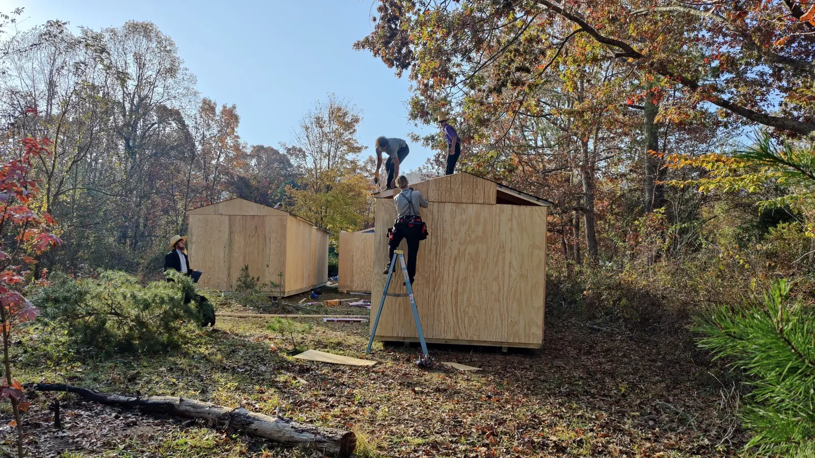 Volunteers working on cabin roofs