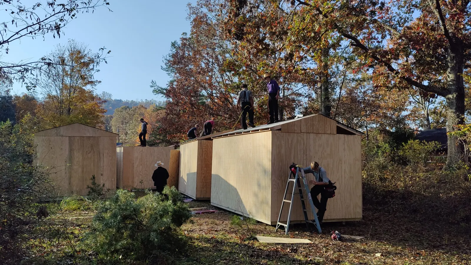 Volunteers finishing cabin exteriors